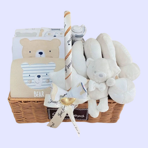 Baby gift basket with teddy bear-themed items on a light purple background